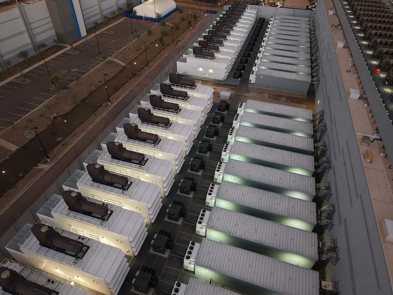 Rows of rooftop cooling equipment on a large data-center building