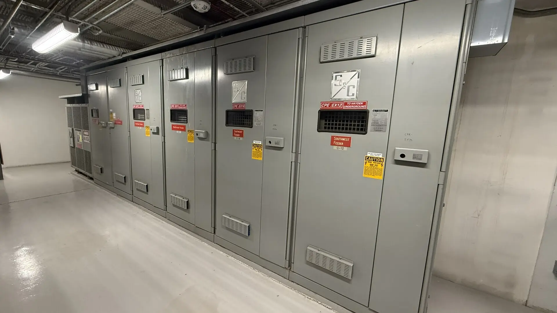 A lineup of electrical switchgear in a clean equipment room