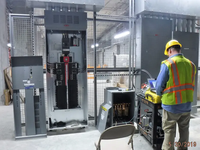 A technician testing newly installed power distribution equipment
